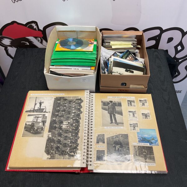 Vintage photo album featuring vehicle and wartime images.