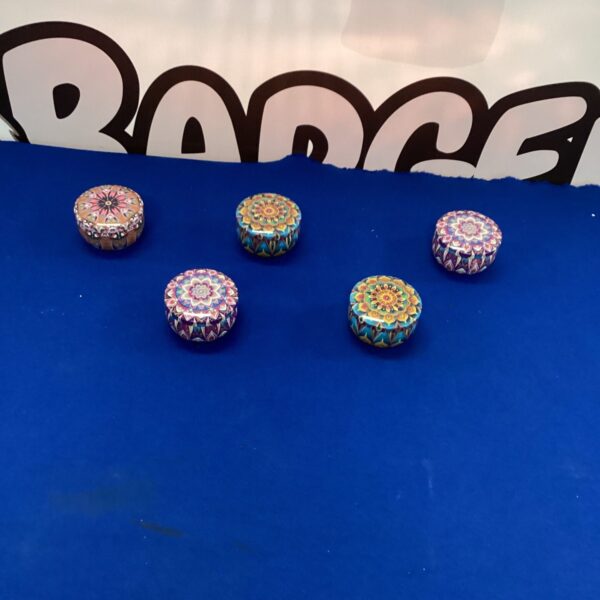 Five colourful metal trinket boxes with patterned lids.