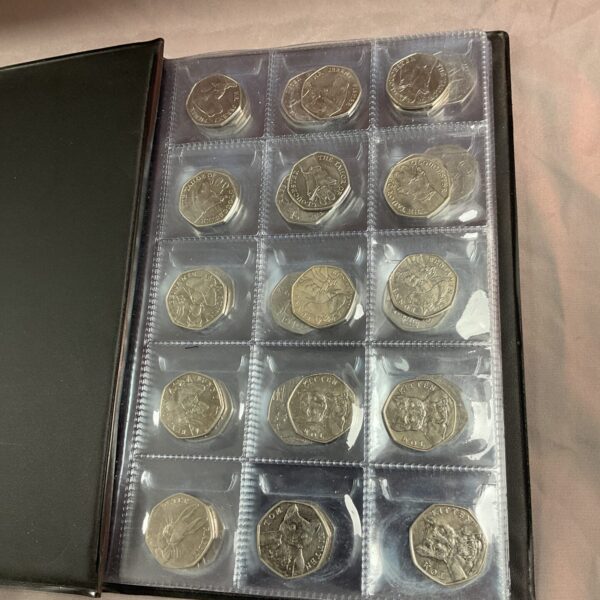 Front view of a coin folder filled with commemorative 50p coins.