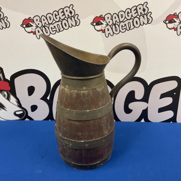 Antique brass banded barrel jug with curved handle and spout.