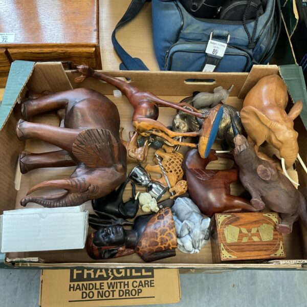 Collection of carved wooden animals including elephants and giraffe.