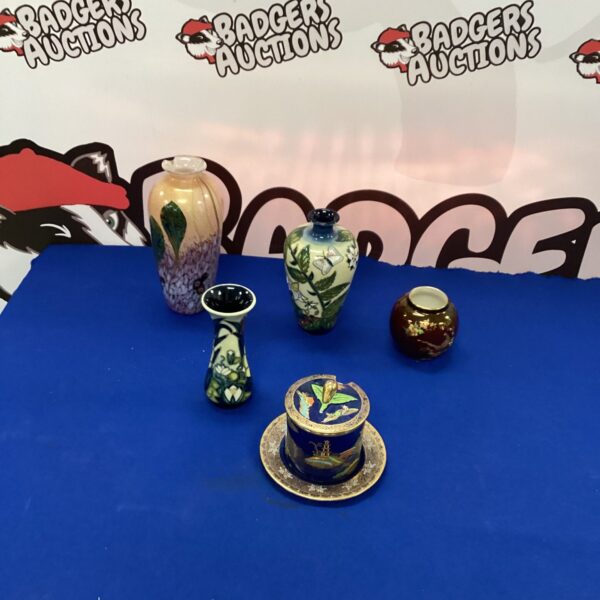 Selection of Moorcroft vases with floral designs.