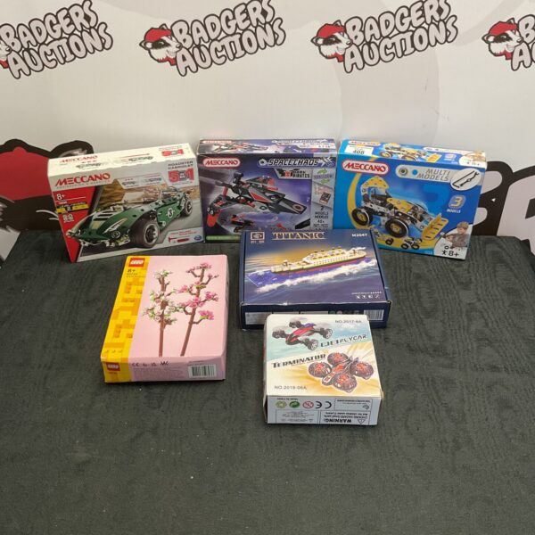 Assortment of boxed Lego and Meccano building kits for collectors.