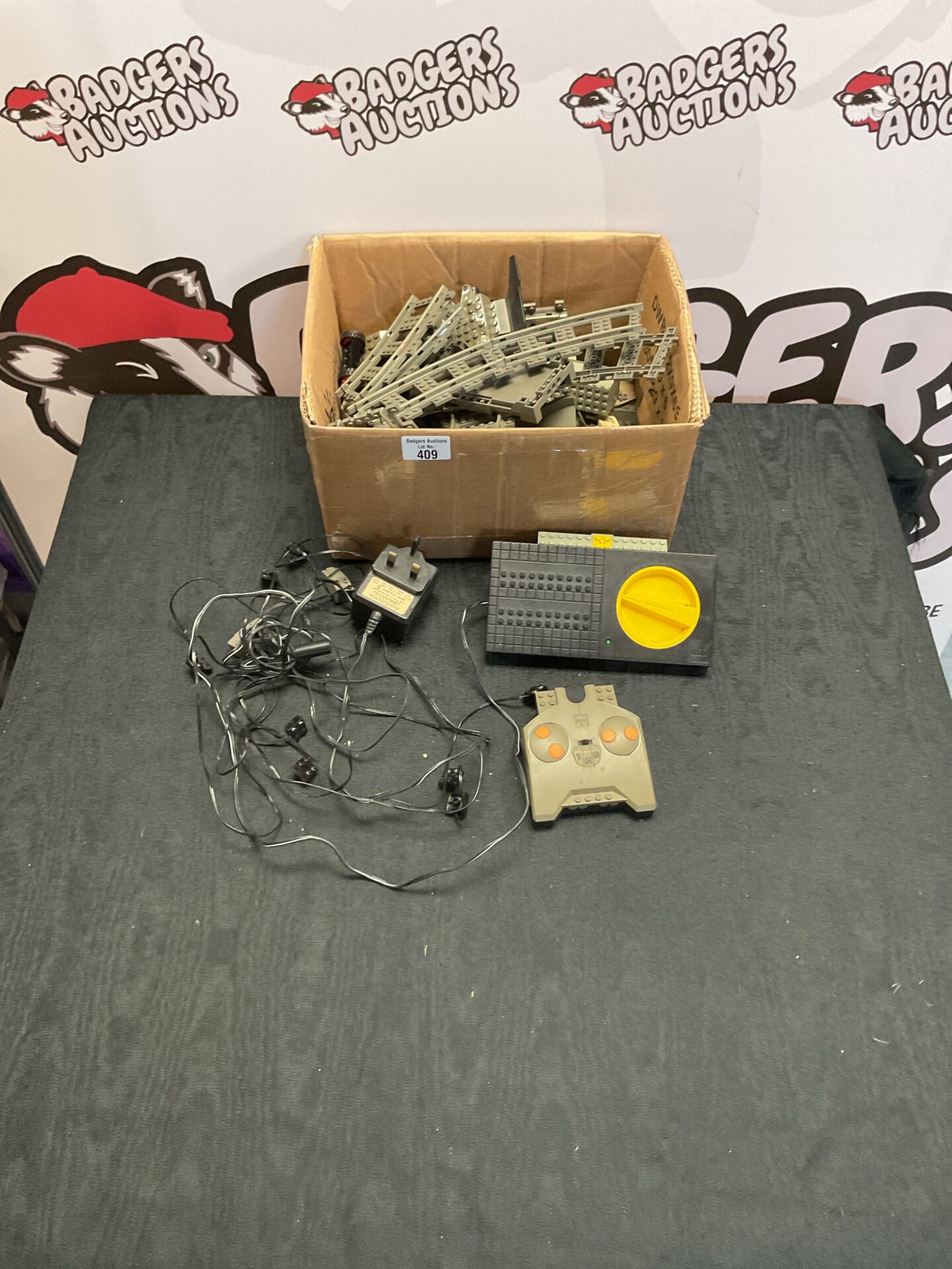 409 Box of vintage Lego train tracks, parts and remote