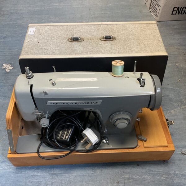 Vintage Frister & Rossman electric sewing machine in original case.