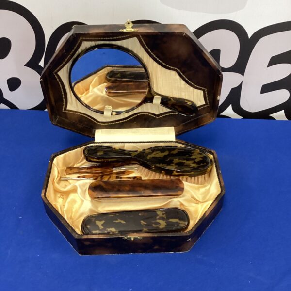 Vintage tortoiseshell dressing table set with mirror and brush.