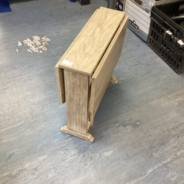 Vintage wooden gate leg table in a light finish.
