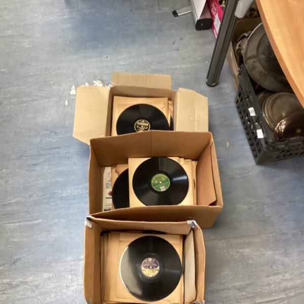 Vintage gramophone records in cardboard boxes, a collectible lot.