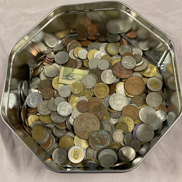 Metal tin filled with a diverse mixed coin lot for collectors.
