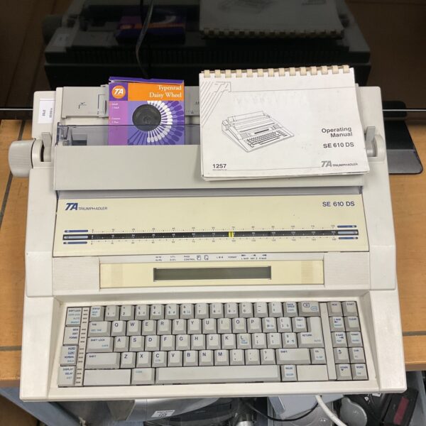 Vintage Triumph Adler SE 610 DS electric typewriter with manual.