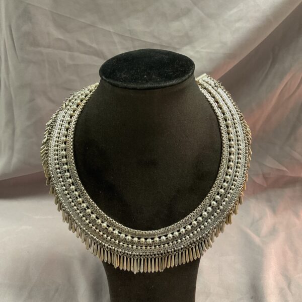 Intricate vintage Indian silver necklace with conical pendants.