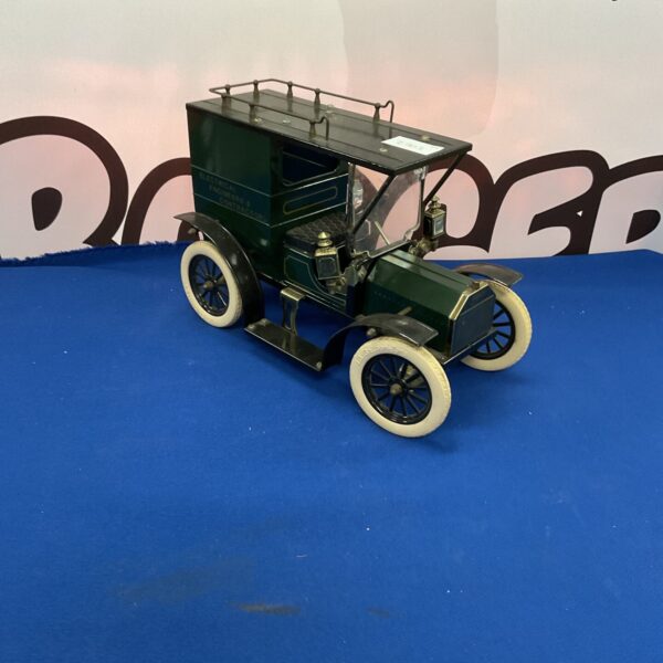 Vintage tinplate Model T Ford Tradesman Van collectible toy.