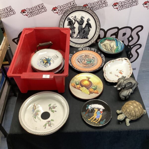 Collection of decorative plates including African and Greek designs.