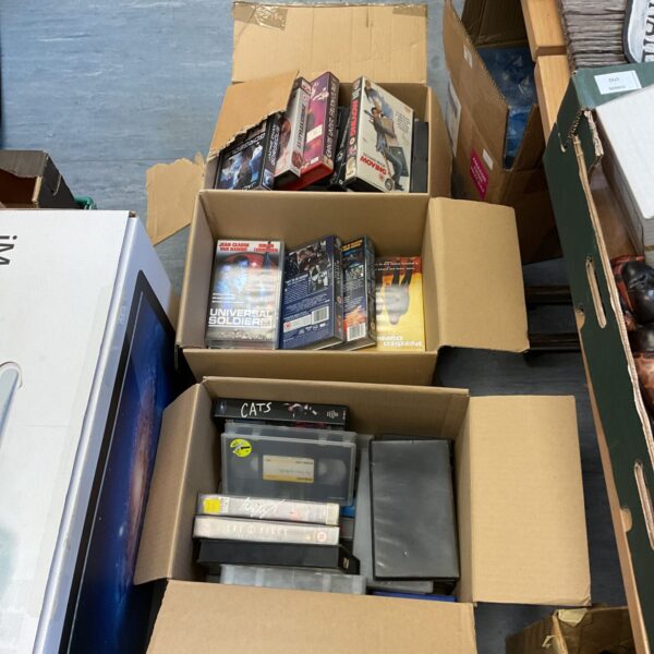 Three boxes of vintage VHS movie cassettes for collectors.