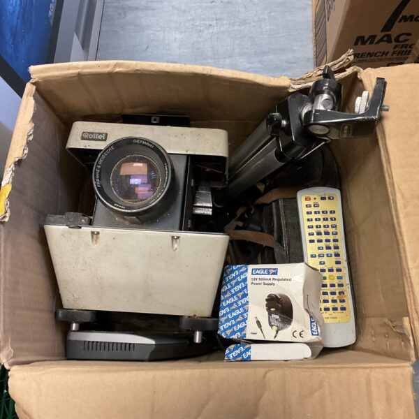 Vintage Rollei P33 projector with Slik tripod for film viewing.