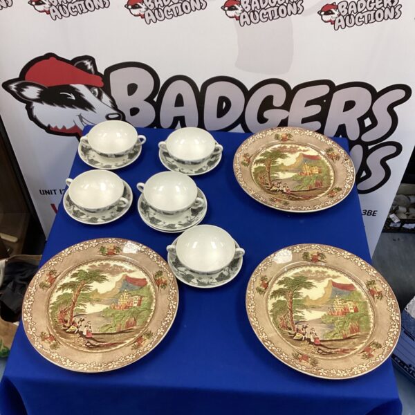 Antique Wedgwood soup bowls and Staffordshire pottery plates on display.