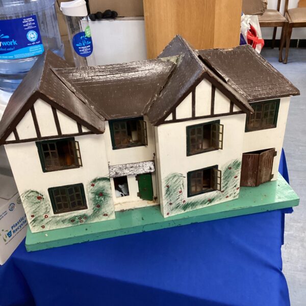 Exterior view of a vintage Triang dolls house with painted details.