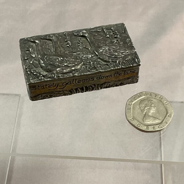 Antique silver trinket box embossed with detailed scenes of geese.