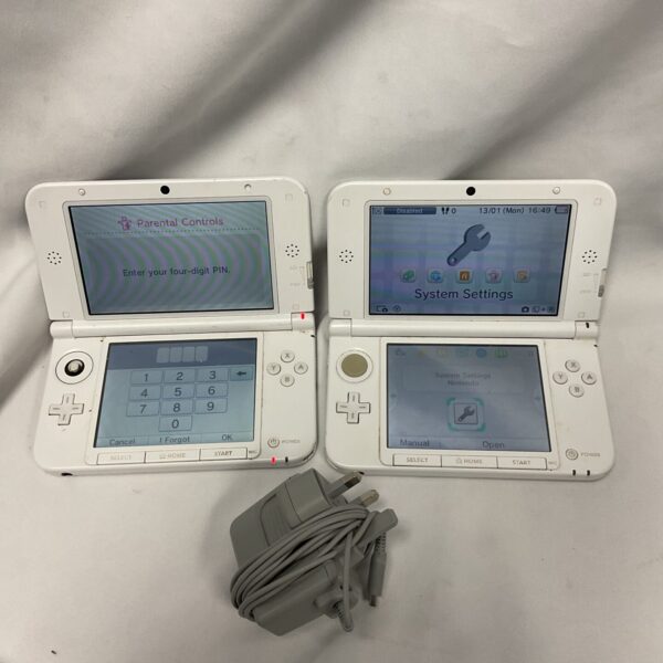 Two Nintendo 3DS XL consoles with charger for portable gaming.