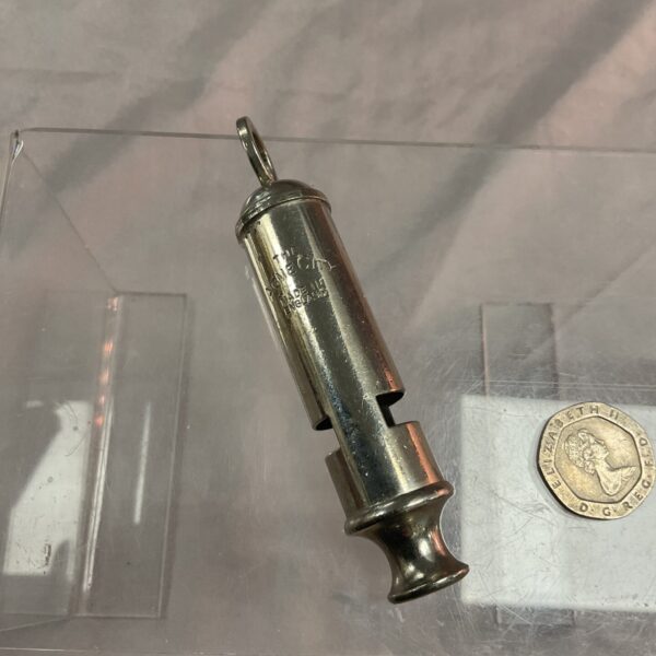 Vintage brass Acme City police whistle, collectible item.