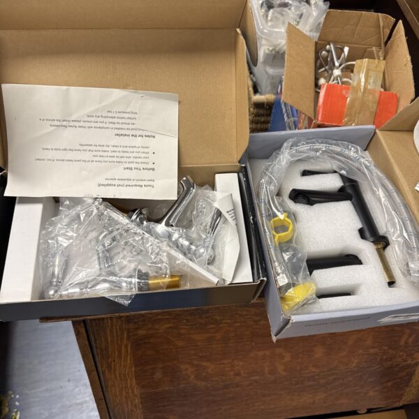 Unused bathroom tap set in original packaging, chrome finish.