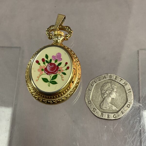 Vintage Hermes ladies pendant watch with floral design.