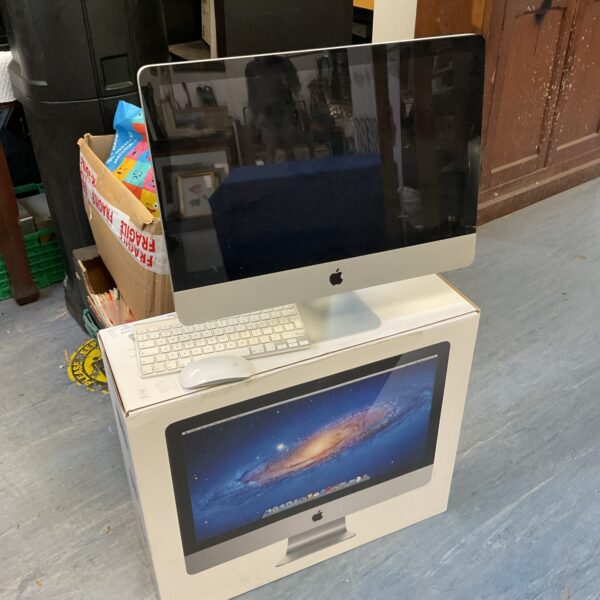 Vintage Apple iMac 21.5 inch computer with keyboard and mouse.