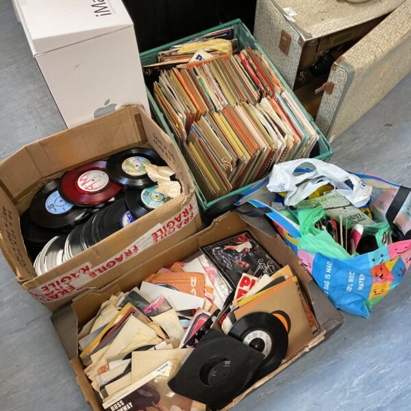 Large lot of vintage 7 inch vinyl records in boxes.