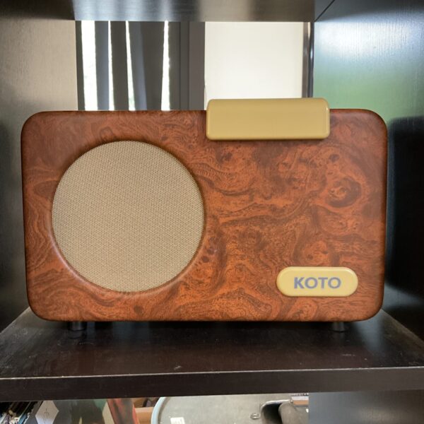 Vintage Koto music player with textured front panel.