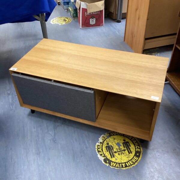 Vintage pine TV stand with open shelf for media storage.