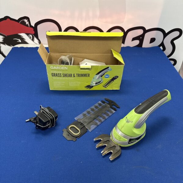 Cordless garden trimmer with charger for garden maintenance.