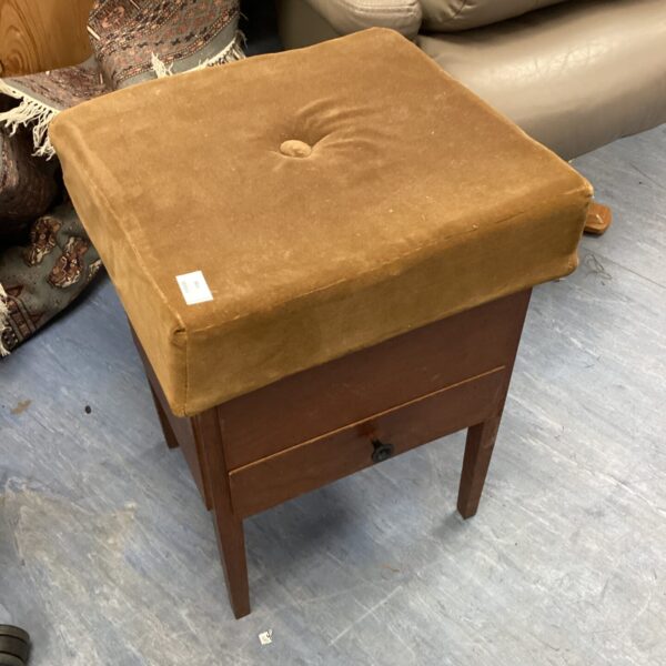 Vintage sewing stool with wooden frame and padded seat.