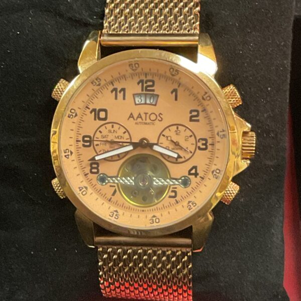Gold AATOS automatic wristwatch with open heart dial.