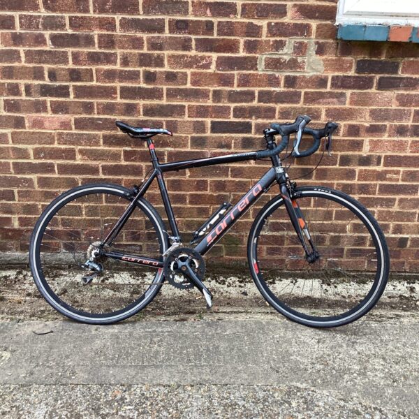 Side view of a black and red Carrera Virtuoso road bike.