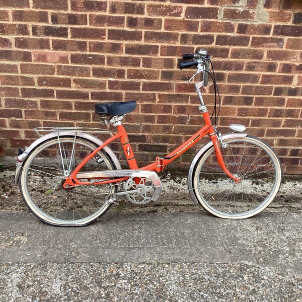 Vintage Peugeot folding bike in a retro style.