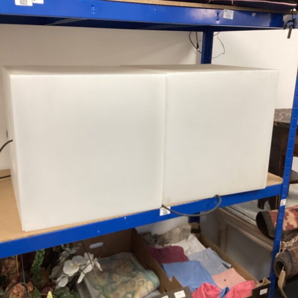 Two white light boxes for photography studio lighting.