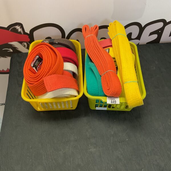Mixed lot of colourful karate belts for martial arts training.