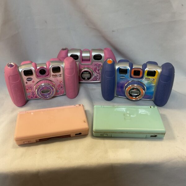 Nintendo DS Lite and VTech camera bundle for gaming and photography.