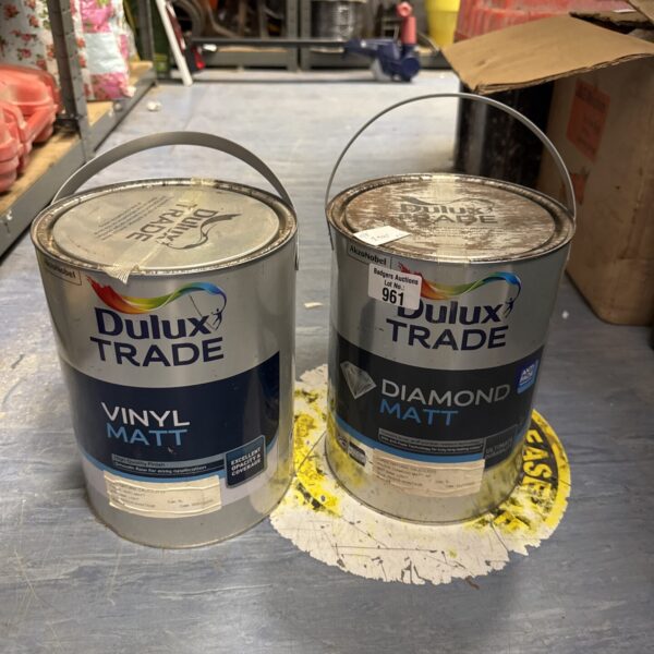 Two sealed tins of Dulux Trade paint for interior decorating.