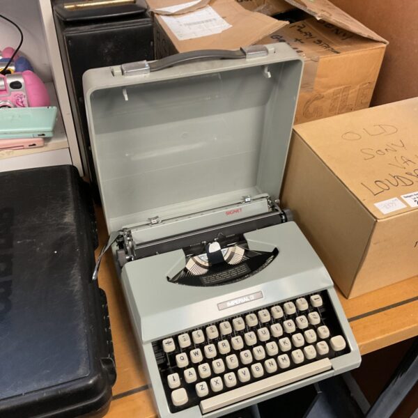 Black Imperial Signet typewriter, vintage mechanical office equipment.