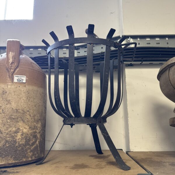 Vintage wrought iron garden fire basket for outdoor use.
