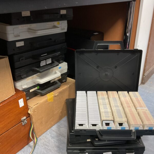 Vintage 35mm slide collection with a slide projector for viewing photos.