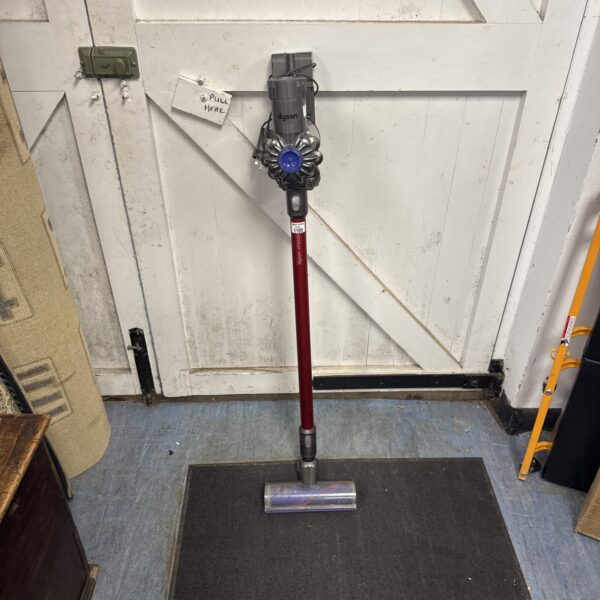 Front view of a grey Dyson V6 cordless vacuum cleaner.