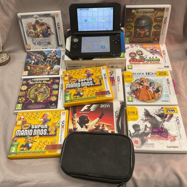 Nintendo 3DS console with eleven game cartridges included.