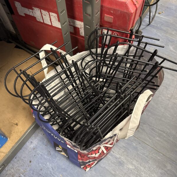 Metal wire garden edging sections for flower beds.
