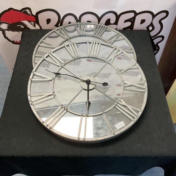 Stylish Dunelm mirrored wall clock for home decoration.