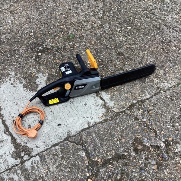 Titan electric chainsaw in used condition, ideal for garden work.