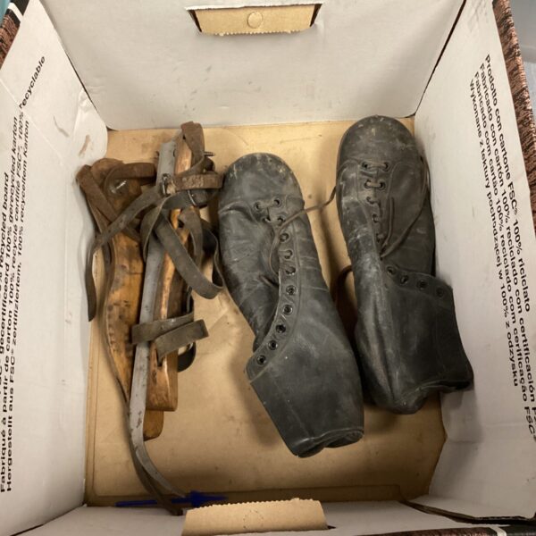 Side view of antique leather skates and boots.