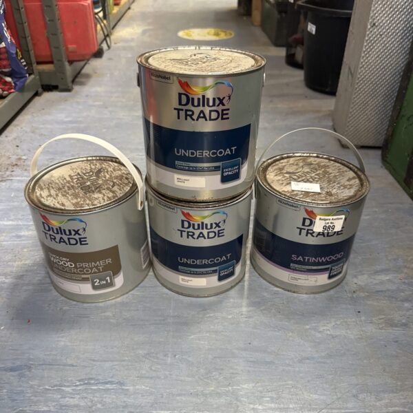 Four full tins of white Dulux Trade paint for interior use.