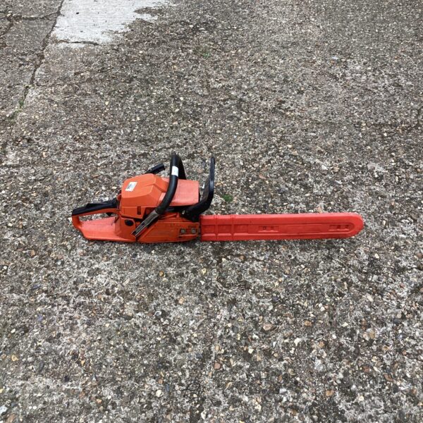 Front view of a petrol chainsaw, a powerful garden tool.